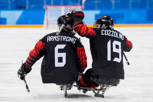 Rob Armstrong of Canada celebrates with teammate Dom