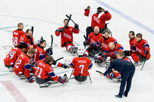 Eskil Hagen of Norway is applauded by teammates and head