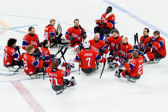 Eskil Hagen of Norway is applauded by teammates