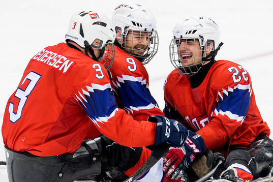 Audun Bakke of Norway celebrates with teammates Rolf Einar