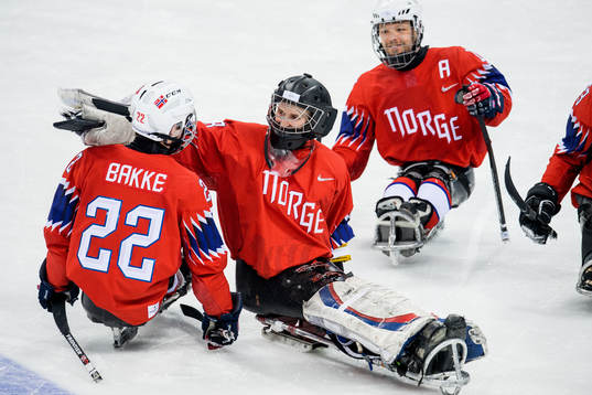 Audun Bakke of Norway celebrates with goaltender Kjell