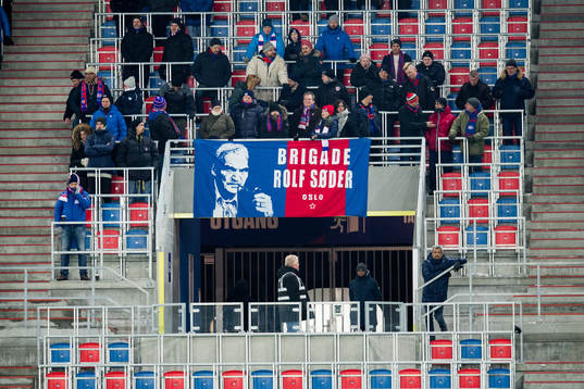 Spectators with a banner of "Brigade Rolf Søder"