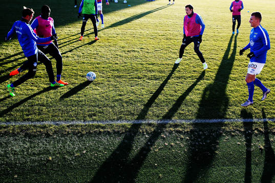 Shadows are seen as the players from Molde warm-up