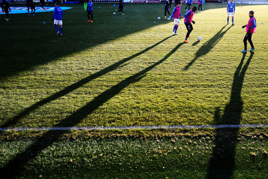 Shadows are seen as the players from Molde warm-up