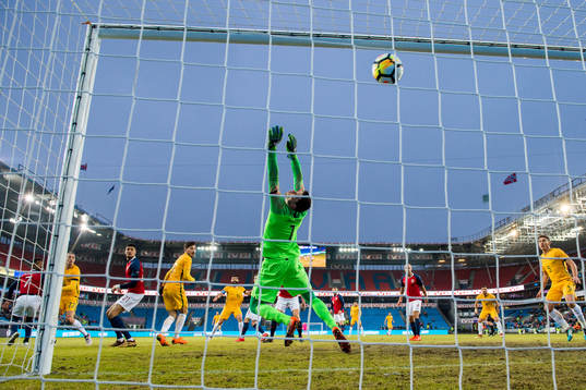 Jackson Irvine of Australia scores 0-1 behind goalkeeper