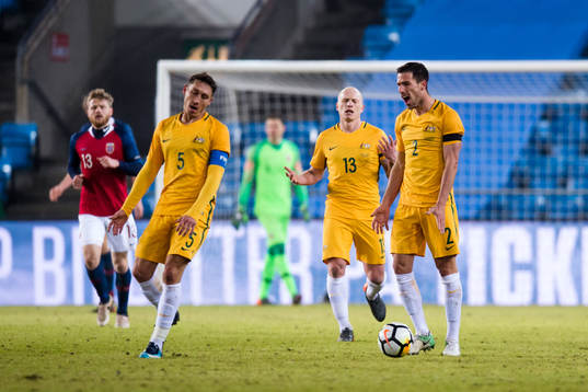 Mark Milligan, Aaron Mooy and Milos Degenek of Australia