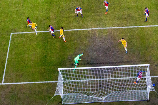 Jackson Irvine of Australia scores 0-1 behind goalkeeper