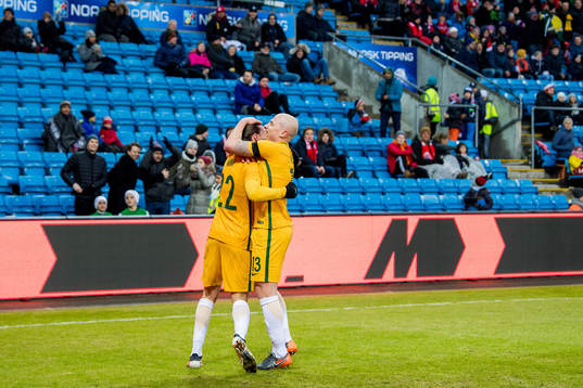 Jackson Irvine of Australia celebrates with teammate Aaron