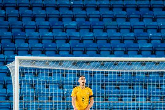 Mark Milligan of Australia looks dejected