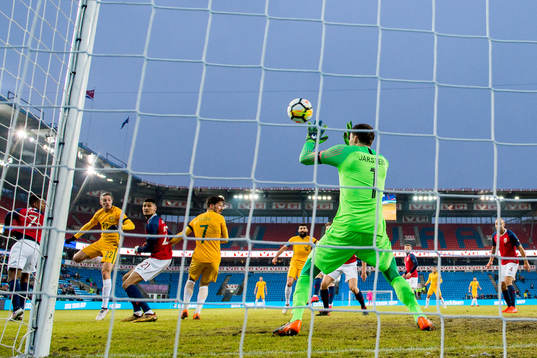 Jackson Irvine of Australia scores 0-1 behind goalkeeper