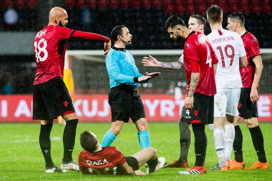 Kamer Qaka of Albania and Fyodor Zammit, referee