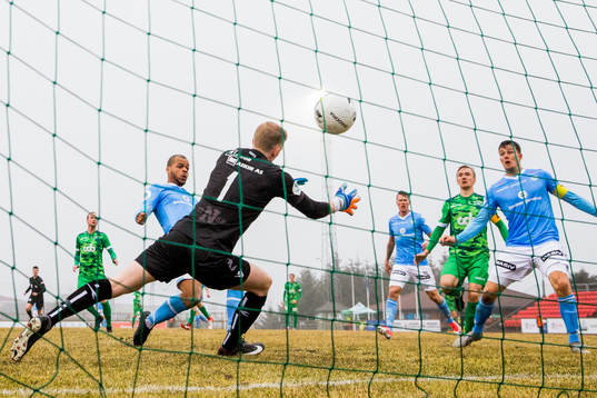 Erixon Danso of Sandnes Ulf scores 1-2 behind goalkeeper