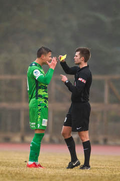 Alexander Dang of Nest-Sotra is shown a yellow card by