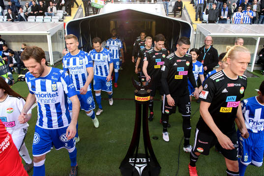 Spelarna går in på arenan innan fotbollsmatchen i