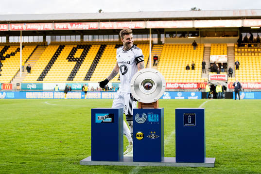 Nicklas Bendtner of Rosenborg walks past the trophy