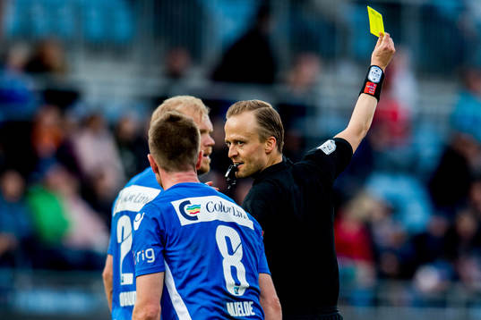 Referee Ola Hobber Nilsen gives a yellow card to Erik