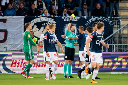 Marcus Pedersen of Strømsgodset is shown a yellow card by