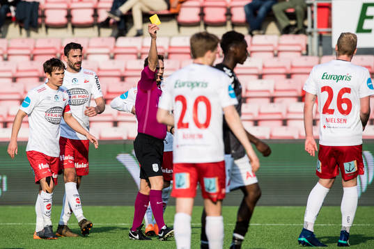 Mads Nielsen of Fredrikstad receives a yellow card of