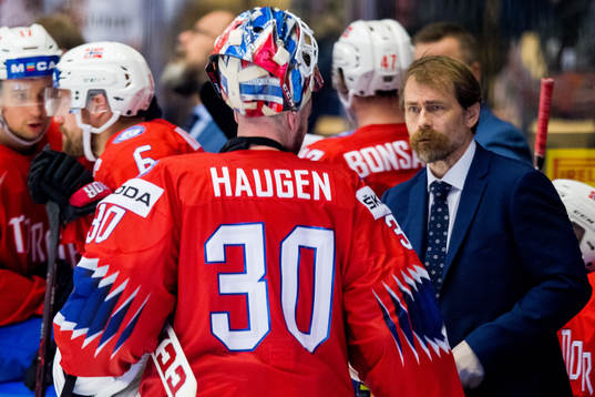 Ole Fosse, team doctor of Norway, talks to goaltender Lars