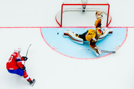 Anders Bastiansen of Norway scores 2-3 behind goaltender