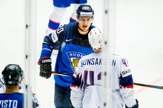 Sebastian Aho of Finland argues with Alexander Bonsaksen of