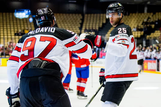 Connor McDavid of Canada celebrates with teammate Darnell