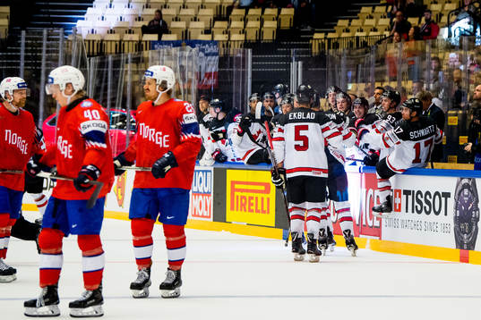 Aaron Ekblad and the players of Canada celebrate