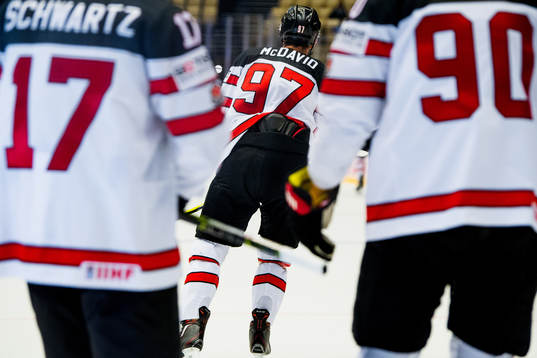 Connor McDavid of Canada celebrates with teammates Jaden