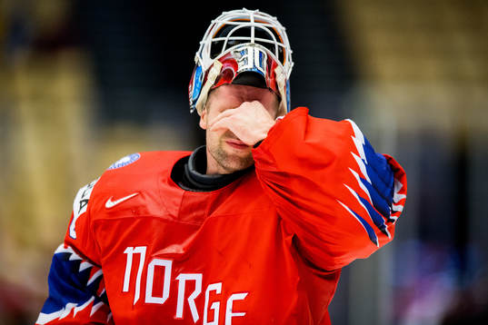 Goaltender Lars Haugen of Norway looks dejected