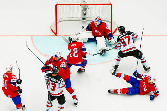 Connor McDavid of Canada scores 4-0 behind goaltender Lars