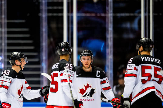 Connor McDavid of Canada celebrates with teammates Ryan