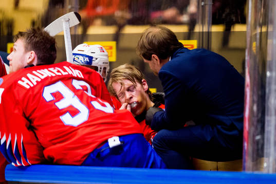 Ken Andre Olimb of Norway gets treatment from Ole Fosse,