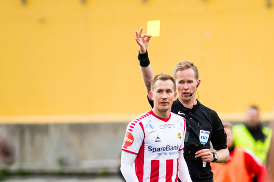 Morten Gamst Pedersen of Tromsø  is shown a yellow card by