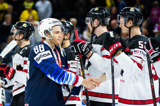 s Patrick Kane tackar de kanadensiska spelarna