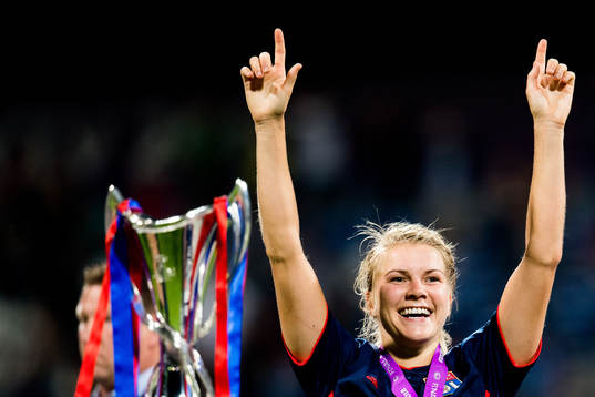 Ada Hegerberg of Lyon celebrates next to the trophy