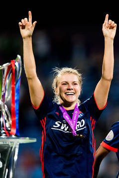 Ada Hegerberg of Lyon celebrates next to the trophy