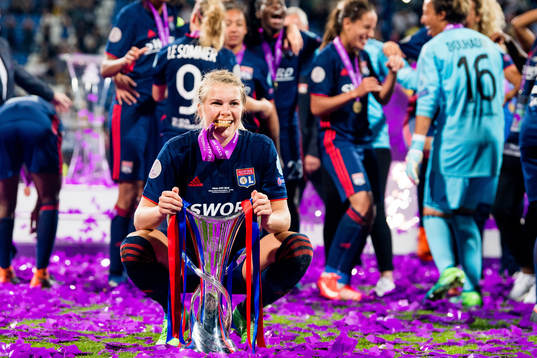 Ada Hegerberg celebrates with the trophy