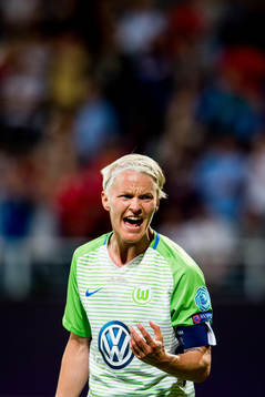 Nilla Fischer of Wolfsburg looks dejected