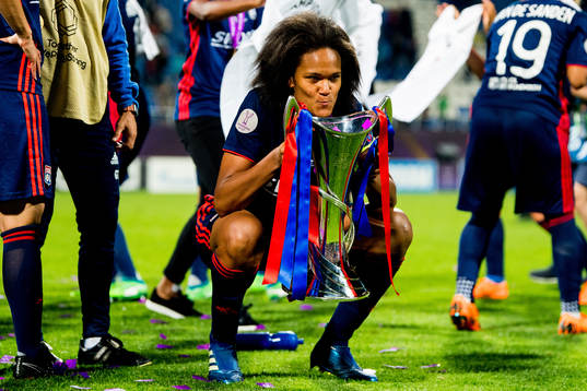 Wendie Renard of Lyon celebrates with the trophy
