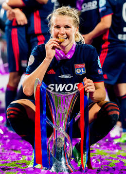 Ada Hegerberg of Lyon celebrates with the trophy