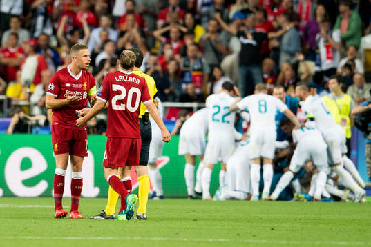 Jordan Henderson of Liverpool discuss with referee Milorad