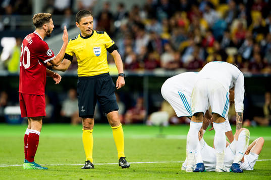 Adam Lallana of Liverpool in discussion with referee