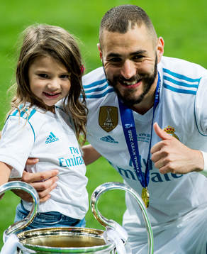 Karim Benzema of Real Madrid celebrates with the trophy