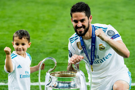 Isco of Real Madrid celebrates with the trophy