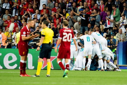 Players of Real Madrid celebrate 1-0 while Jordan Henderson