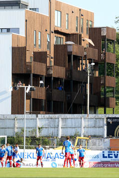 Spectators watch the game from surrounding buildinsg