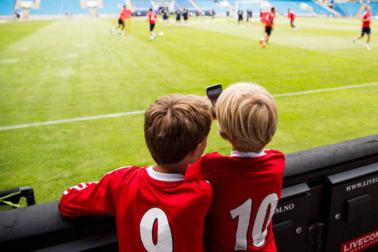Children watch the players of Norway
