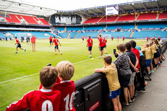 Children watch the players of Norway