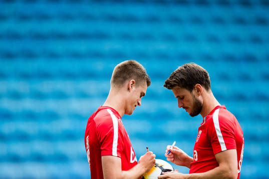 Markus Henriksen and Håvard Nordtveit of Norway sign a ball