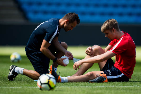 Kristoffer Ajer of Norway with an injury